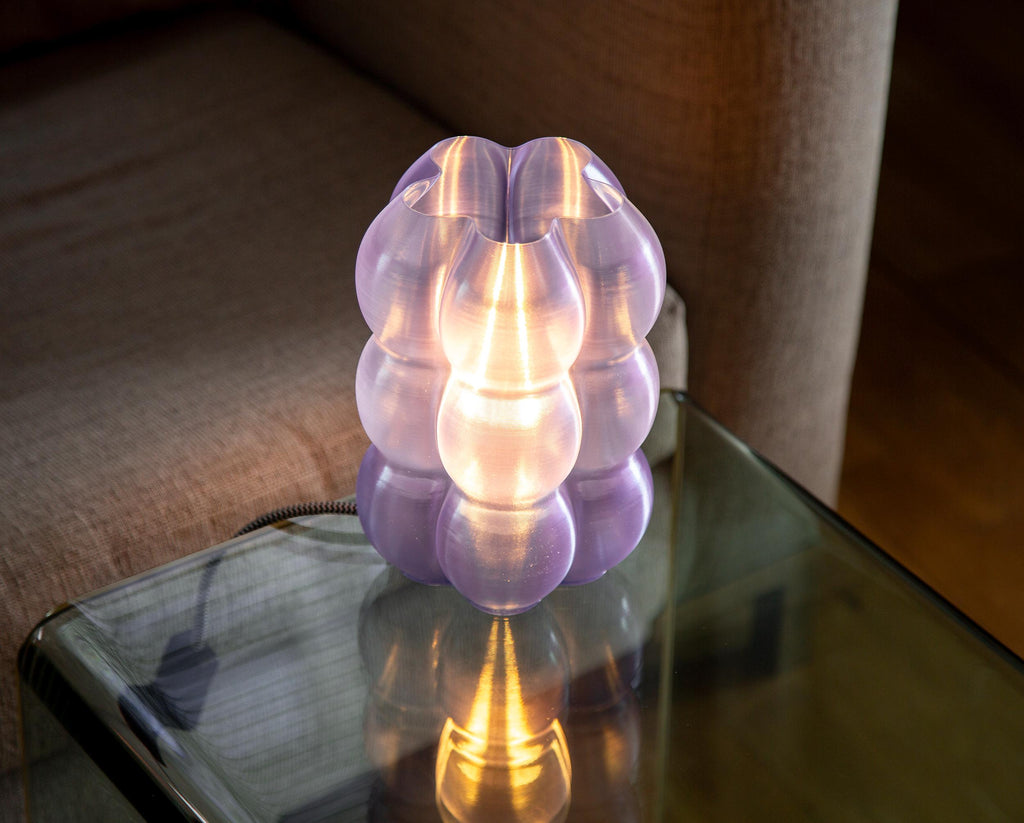 A close-up of a glowing dome-shaped lampshade made of warm translucent material, with centered text describing high-precision printing and light diffusion.